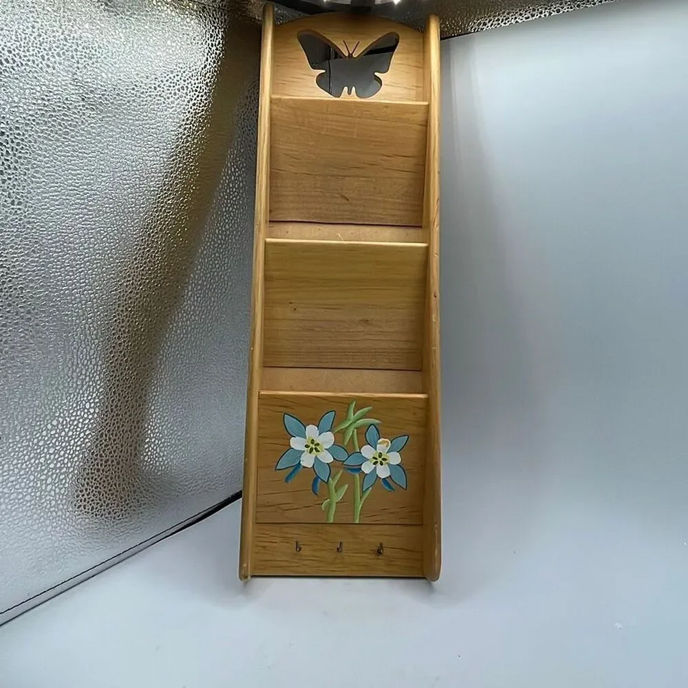 Vintage wooden wall organizer for keys and mail.